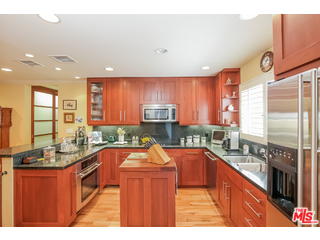 281 South Barrington Avenue, Unit C2 Los Angeles, CA 90049 - Photo 11 of 24 a kitchen with stainless steel appliances granite countertop sink stove top oven and cabinets