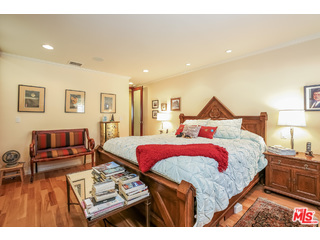 281 South Barrington Avenue, Unit C2 Los Angeles, CA 90049 - Photo 12 of 24 a bedroom with bed and wooden floor