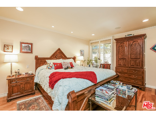 281 South Barrington Avenue, Unit C2 Los Angeles, CA 90049 - Photo 13 of 24 a bedroom with a bed and wooden floor