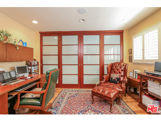 281 South Barrington Avenue, Unit C2 Los Angeles, CA 90049 - Photo 15 of 24 a living room with furniture a flat screen tv and a window