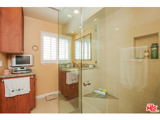 281 South Barrington Avenue, Unit C2 Los Angeles, CA 90049 - Photo 16 of 24 a bathroom with a sink and a mirror