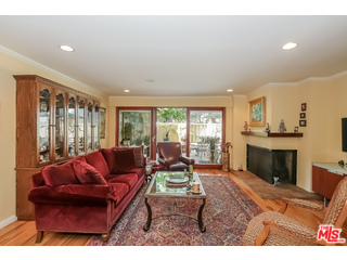 281 South Barrington Avenue, Unit C2 Los Angeles, CA 90049 - Photo 5 of 24 a living room with furniture a fireplace and a flat screen tv