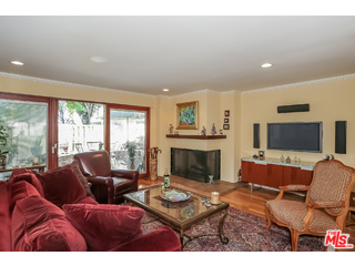 281 South Barrington Avenue, Unit C2 Los Angeles, CA 90049 - Photo 6 of 24 a living room with furniture a flat screen tv and a fireplace