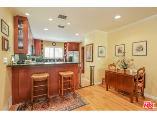 281 South Barrington Avenue, Unit C2 Los Angeles, CA 90049 - Photo 8 of 24 a living room with stainless steel appliances kitchen island granite countertop furniture and a kitchen view
