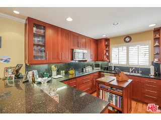 281 South Barrington Avenue, Unit C2 Los Angeles, CA 90049 - Photo 9 of 24 a living room with furniture a rug and a window