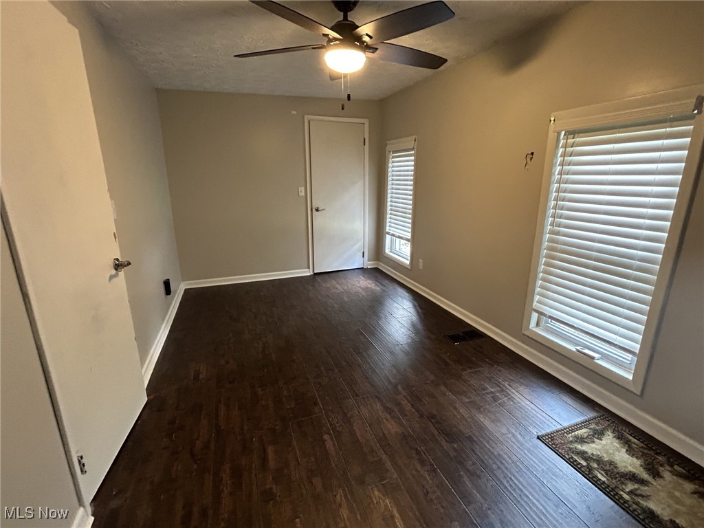 4853 Leon Road Andover, OH 44003 - Photo 29 of 33 Unfurnished room with a textured ceiling, ceiling fan, and dark hardwood / wood-style floors