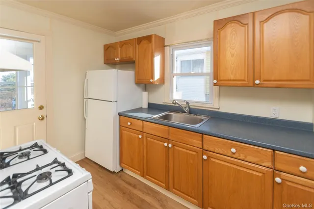 a kitchen with sink a refrigerator and a stove