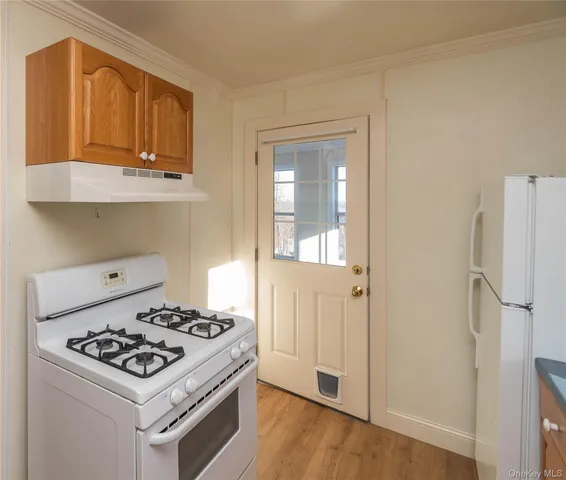 a kitchen with a stove and a refrigerator
