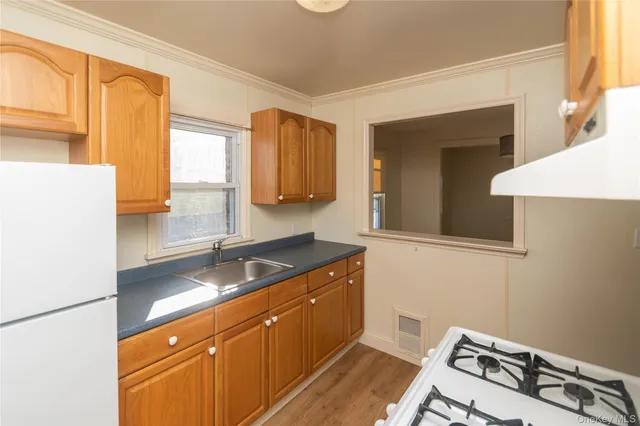 a kitchen with a refrigerator and a sink