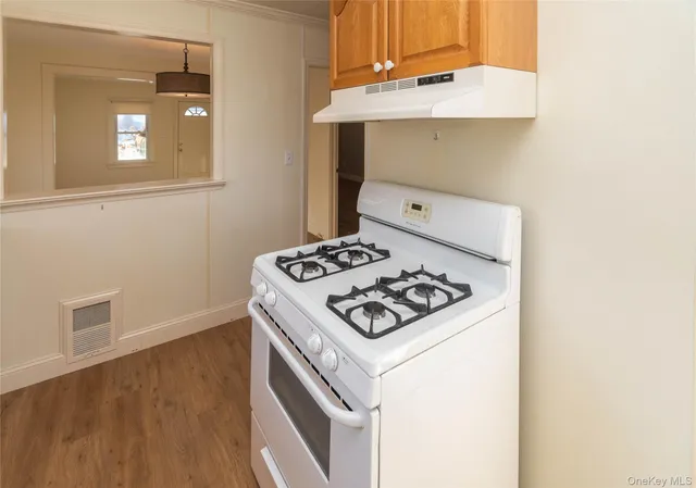 a white stove top oven sitting inside of a house