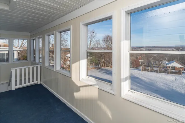 a view of an entryway with wooden floor and windows