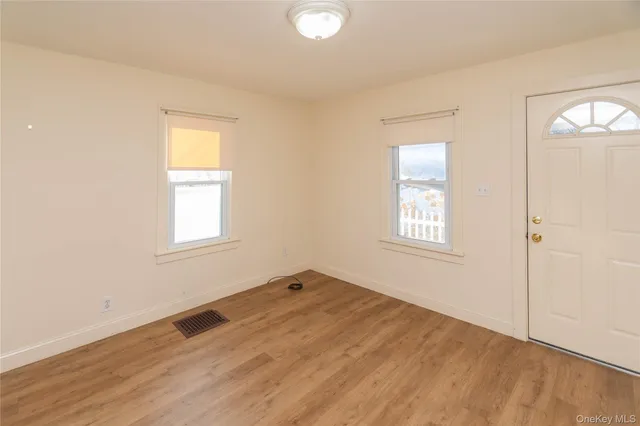 an empty room with windows and closet