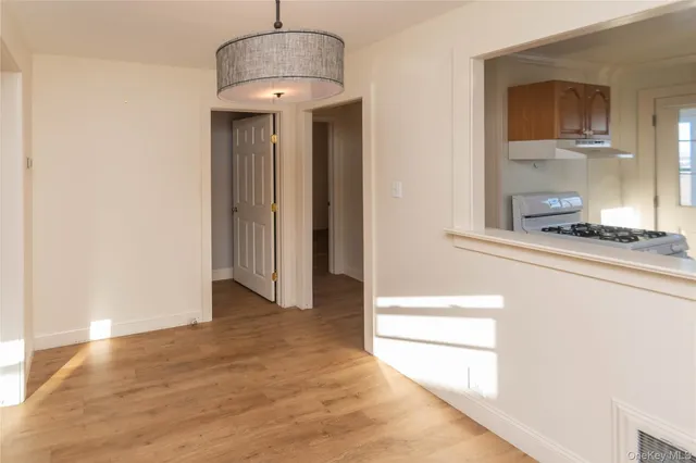 a hallway with a sink and a mirror