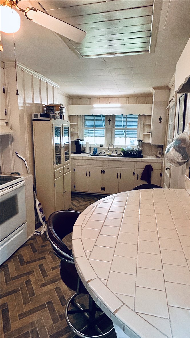 608 29 N Bypass Anderson, SC 29621 - Photo 12 of 20 A quaint kitchen with tile flooring offers ample space for meal preparation and casual dining.