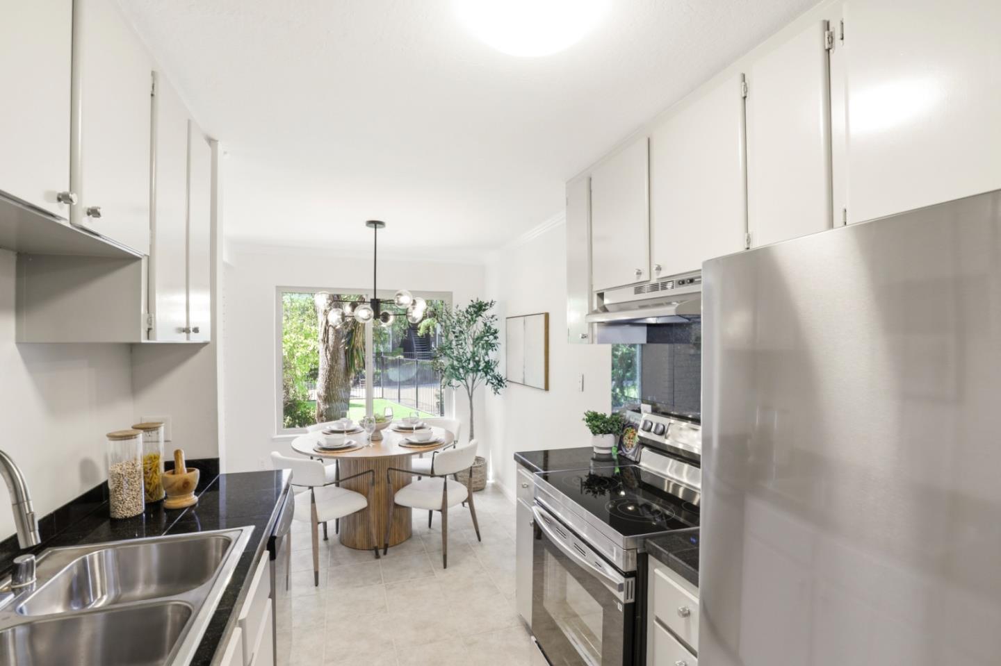 100 East Middlefield Road, Unit 3B Mountain View, CA 94043 - Photo 11 of 32 a kitchen with stainless steel appliances a stove a sink and a refrigerator