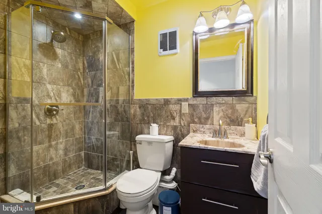 a bathroom with a sink toilet and shower