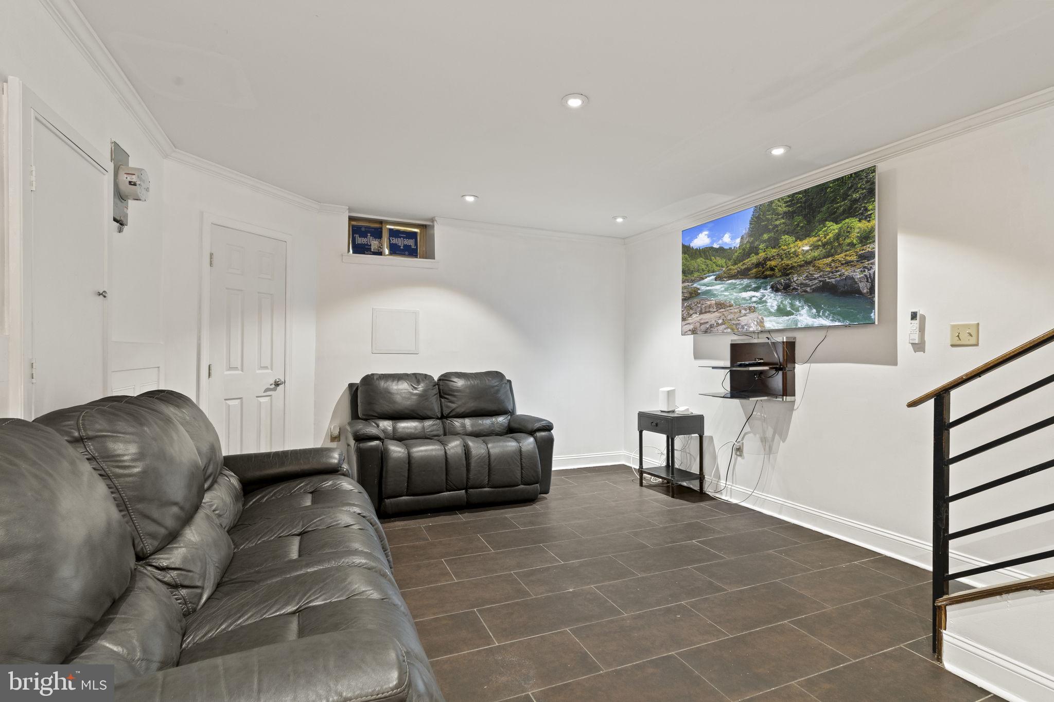 2006 Ellsworth Street Philadelphia, PA 19146 - Photo 13 of 34 a living room with furniture and a flat screen tv