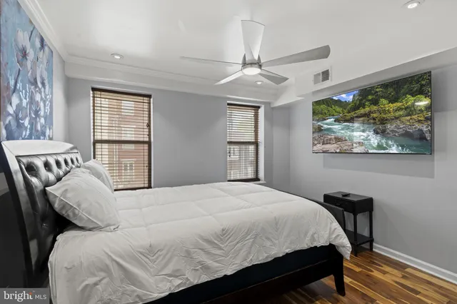 a bathroom with a granite countertop sink a toilet a mirror and shower