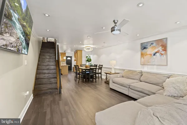 a living room with furniture and wooden floor