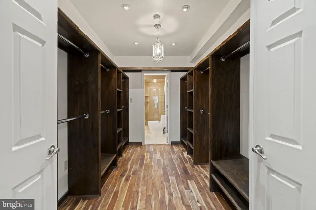 a spacious bedroom with a bed and wooden floor