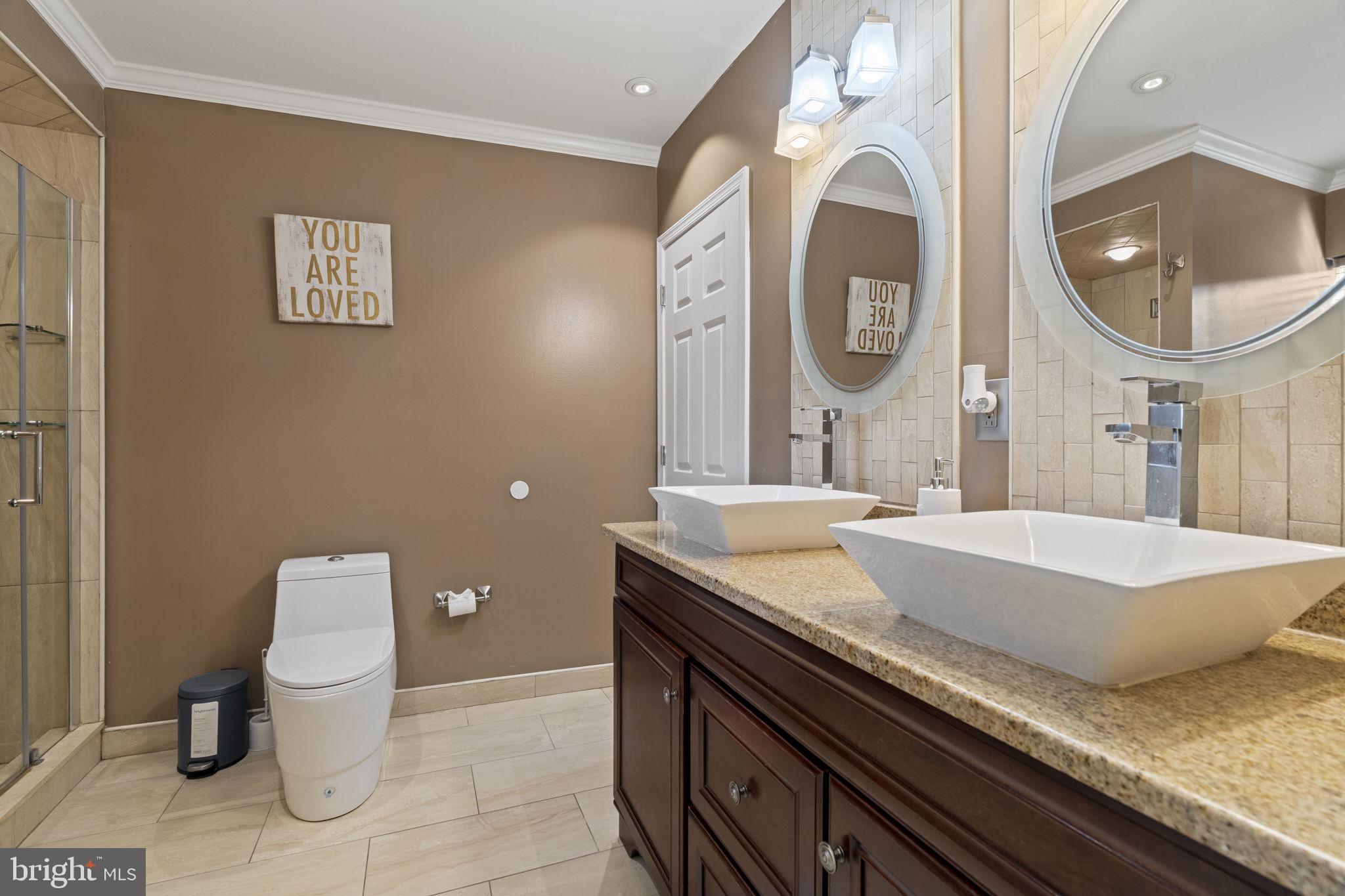 2006 Ellsworth Street Philadelphia, PA 19146 - Photo 25 of 34 a bathroom with a granite countertop toilet a sink and a mirror