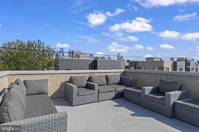 a dinning table and chairs with the view of city