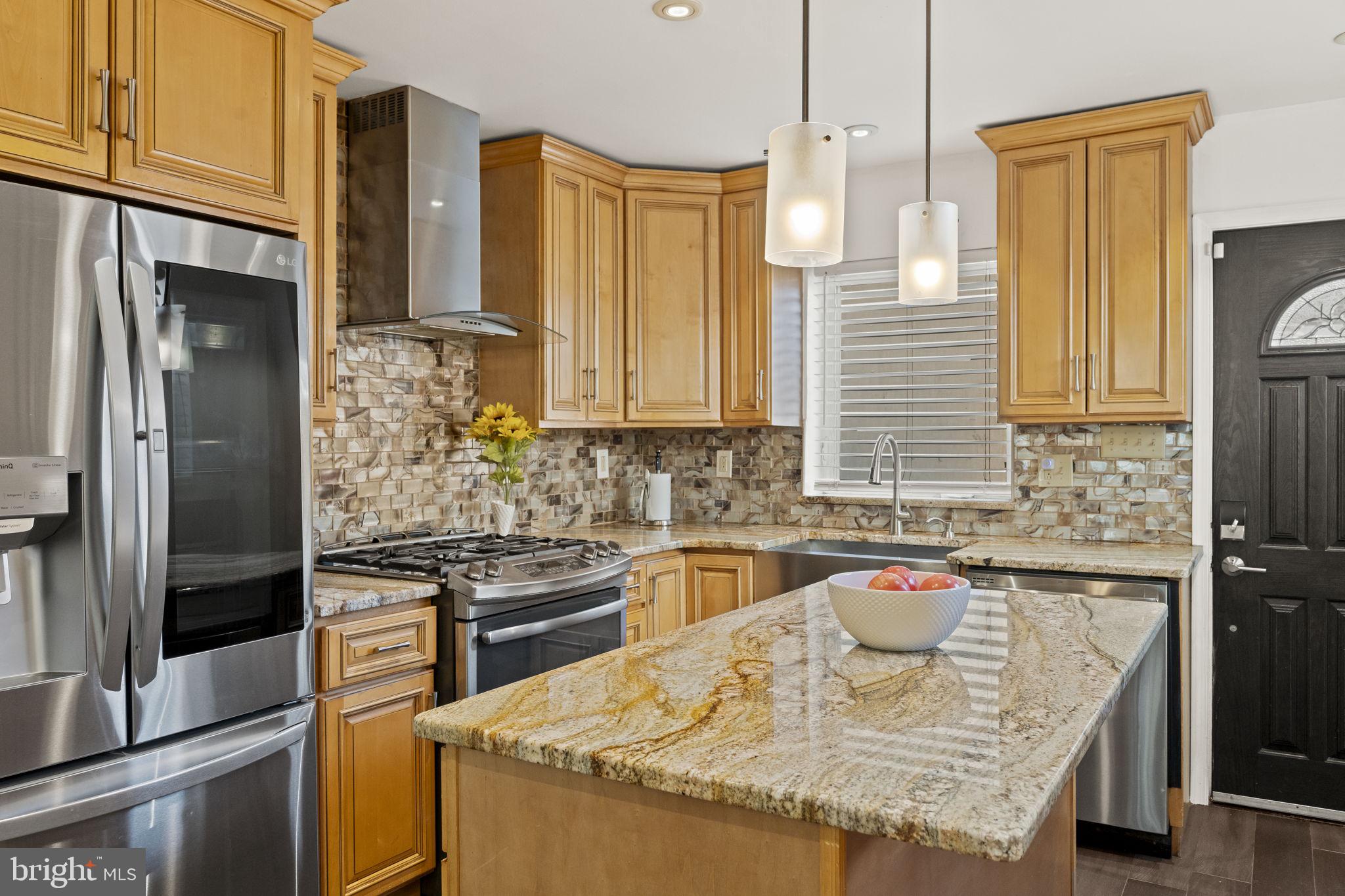 2006 Ellsworth Street Philadelphia, PA 19146 - Photo 7 of 34 a kitchen with granite countertop a sink and stainless steel appliances