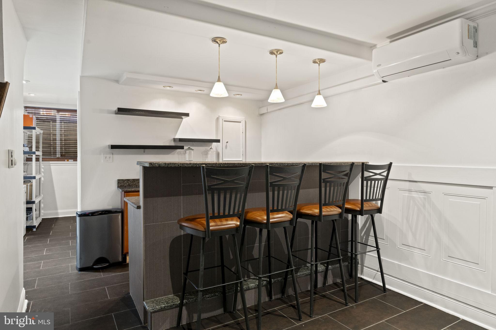 2006 Ellsworth Street Philadelphia, PA 19146 - Photo 10 of 34 a kitchen with a sink a refrigerator and chairs