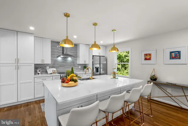 a kitchen with a table chairs and white appliances