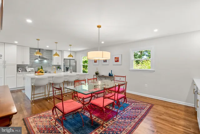a living room with furniture a fireplace and a potted plant
