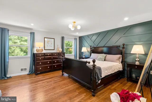 a bed room with bed and a chandelier