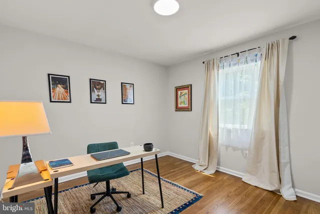 a workspace with furniture and wooden floor