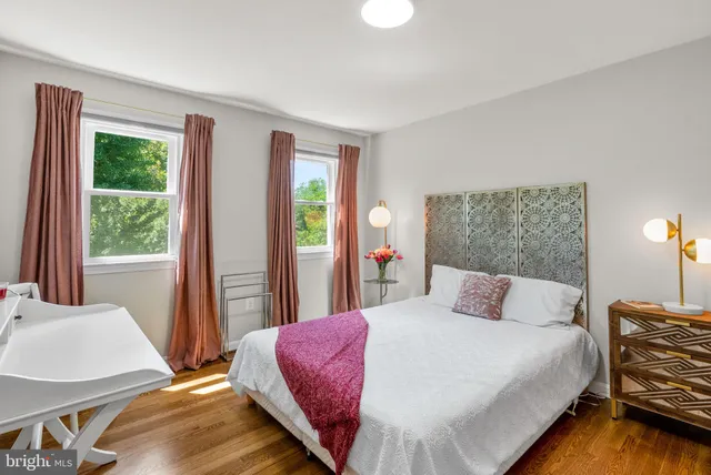 a bed room with a bed and a desk