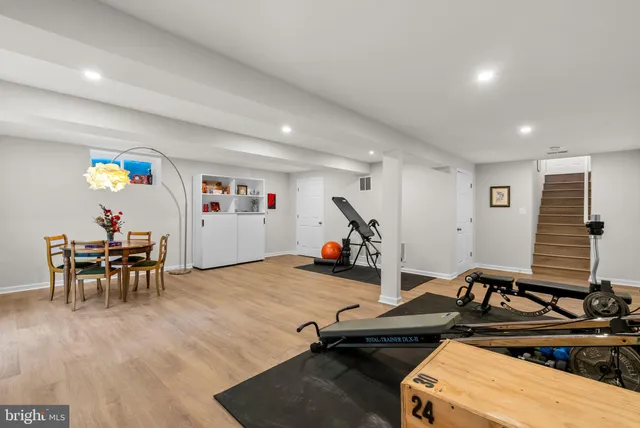 an outdoor sitting area with furniture and garden