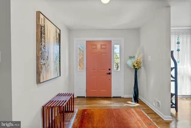 a living room with furniture a rug and a window