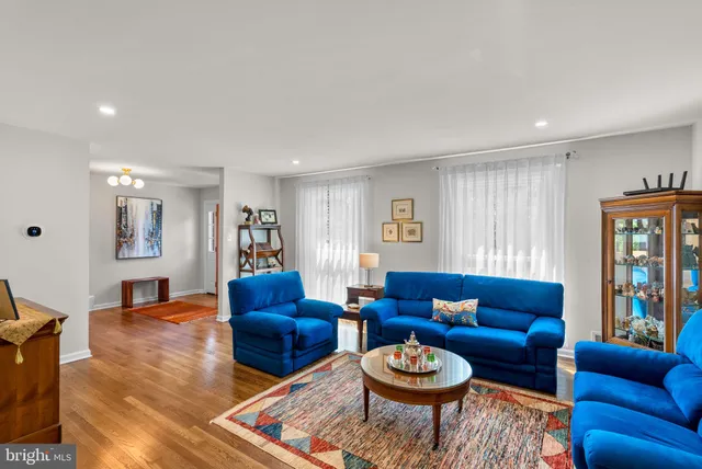 a living room with furniture kitchen and a table