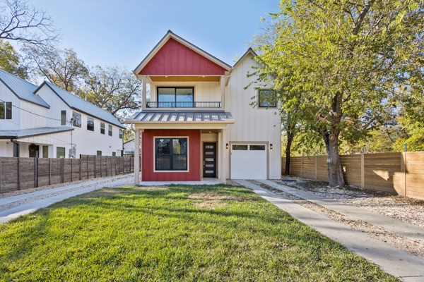 a front view of a house with yard and green space