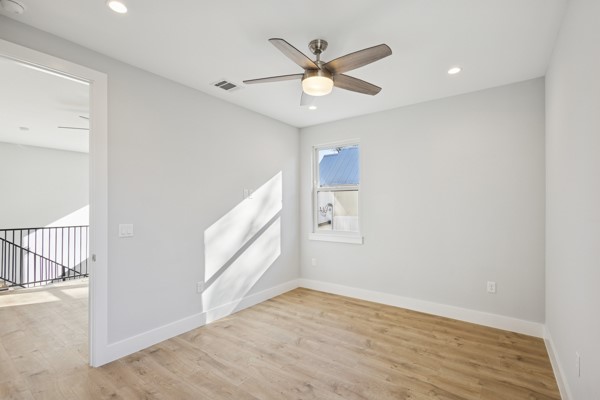 4801 Prock Lane, Unit A Austin, TX 78721 - Photo 14 of 24 an empty room with wooden floor and windows