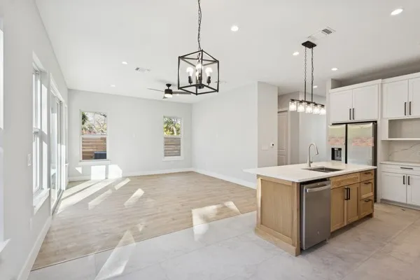 a view of a kitchen with a sink and chandelier