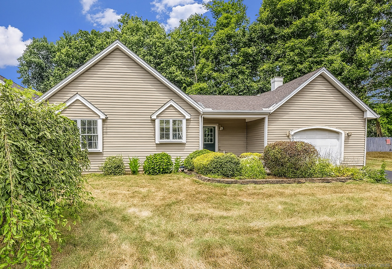 a view of house with yard