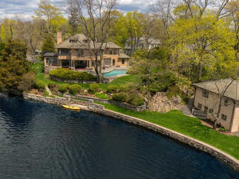 22 Searles Road Darien, CT 06820 - Photo 1 of 25 a view of a lake with a house in the background