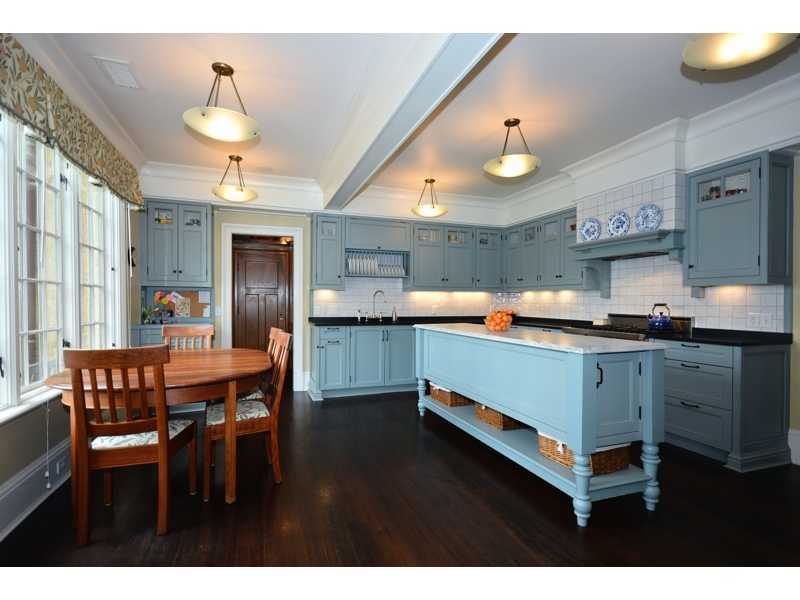 22 Searles Road Darien, CT 06820 - Photo 12 of 25 a kitchen with stainless steel appliances granite countertop a sink a stove and chairs