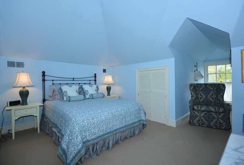 22 Searles Road Darien, CT 06820 - Photo 18 of 25 a bedroom with a bed and window