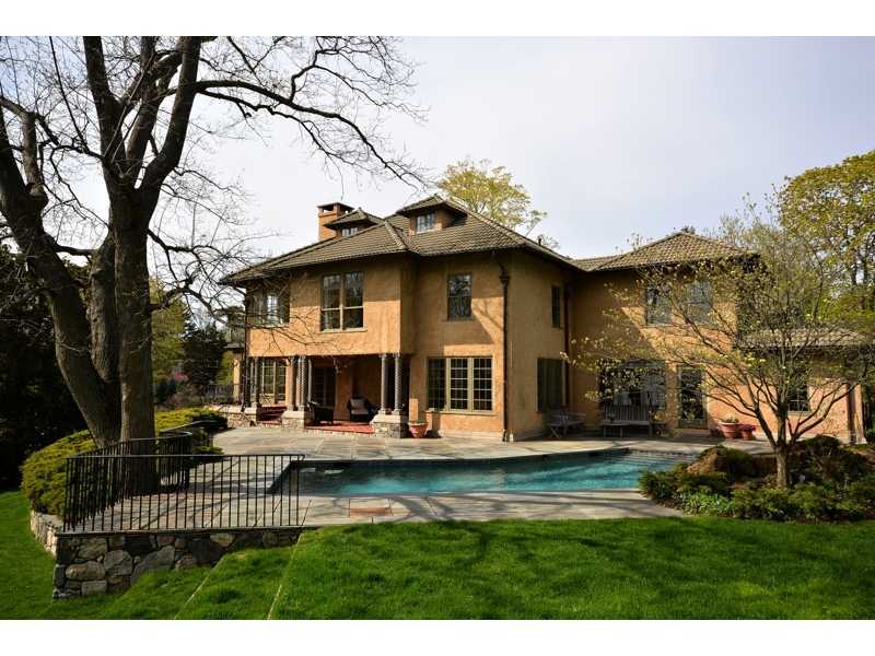 22 Searles Road Darien, CT 06820 - Photo 6 of 25 a front view of a house with a yard table and chairs