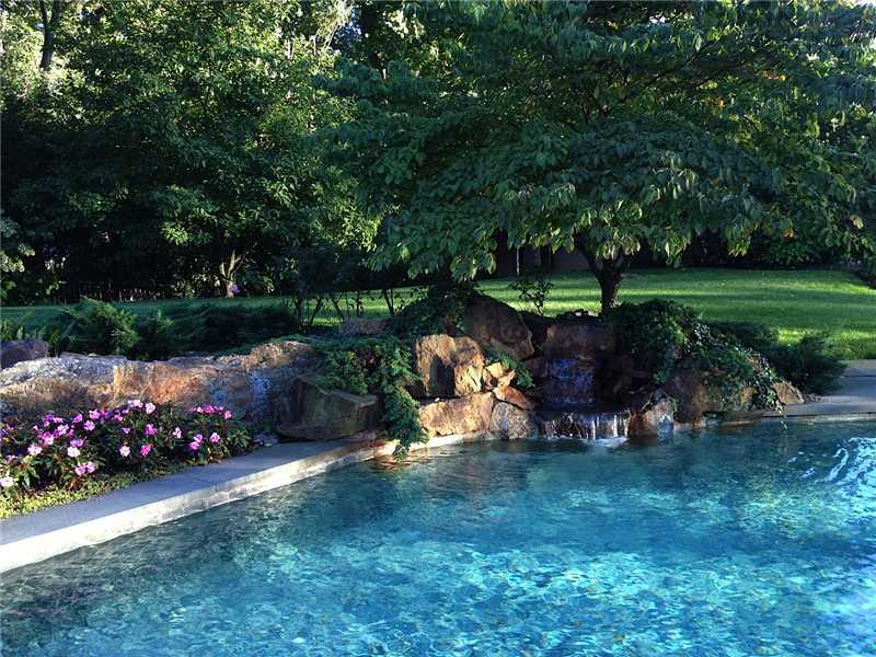 22 Searles Road Darien, CT 06820 - Photo 7 of 25 a view of a garden with plants and large trees