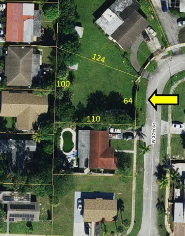 an aerial view of a house with a garden and trees