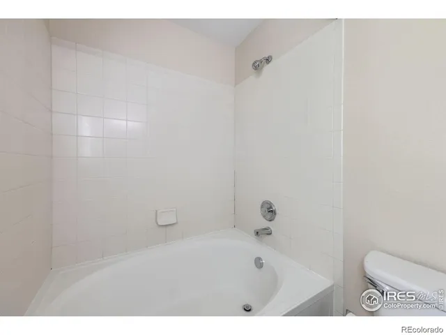 a bathroom with a toilet and a tub