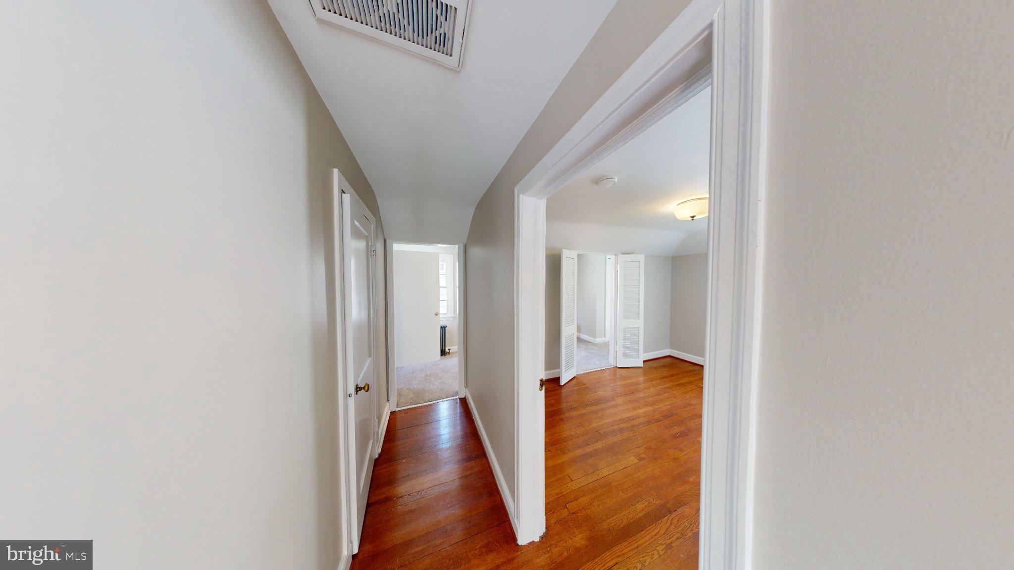 7309 River Road Bethesda, MD 20817 - Photo 20 of 34 Inviting hallway with warm wood floors.