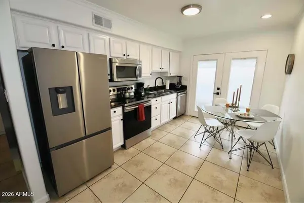 a kitchen with stainless steel appliances a refrigerator stove microwave and cabinets