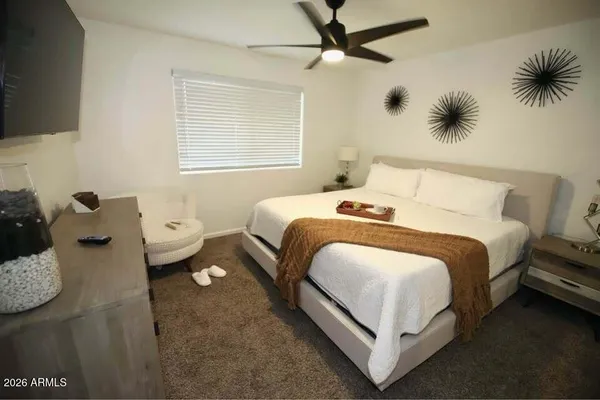 a bedroom with a bed and a window